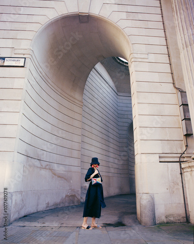 Woman in Stylish Outfit Standing Near Urban Architecture photo