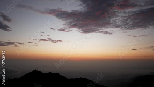 Beautiful Sunset with View of the  Clouds Between the Hills from the Viewpoint “Apu Siqay”,  in Villa del Triunfo, Lima, Peru   photo