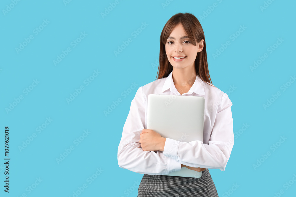 Beautiful young businesswoman with modern laptop on blue background Beautiful young businesswoman with modern laptop on blue background