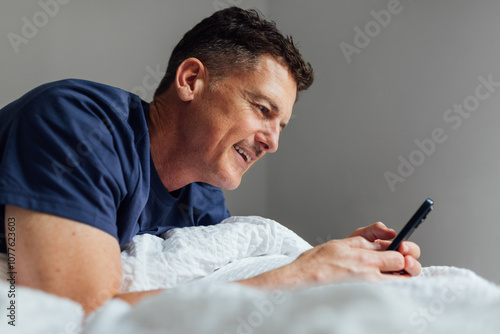 Texting in bed photo