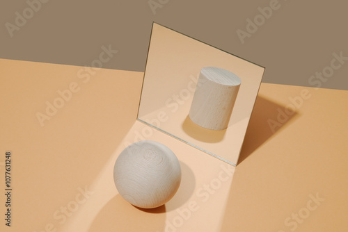 ball in front of a mirror reflects the image of a cylinder