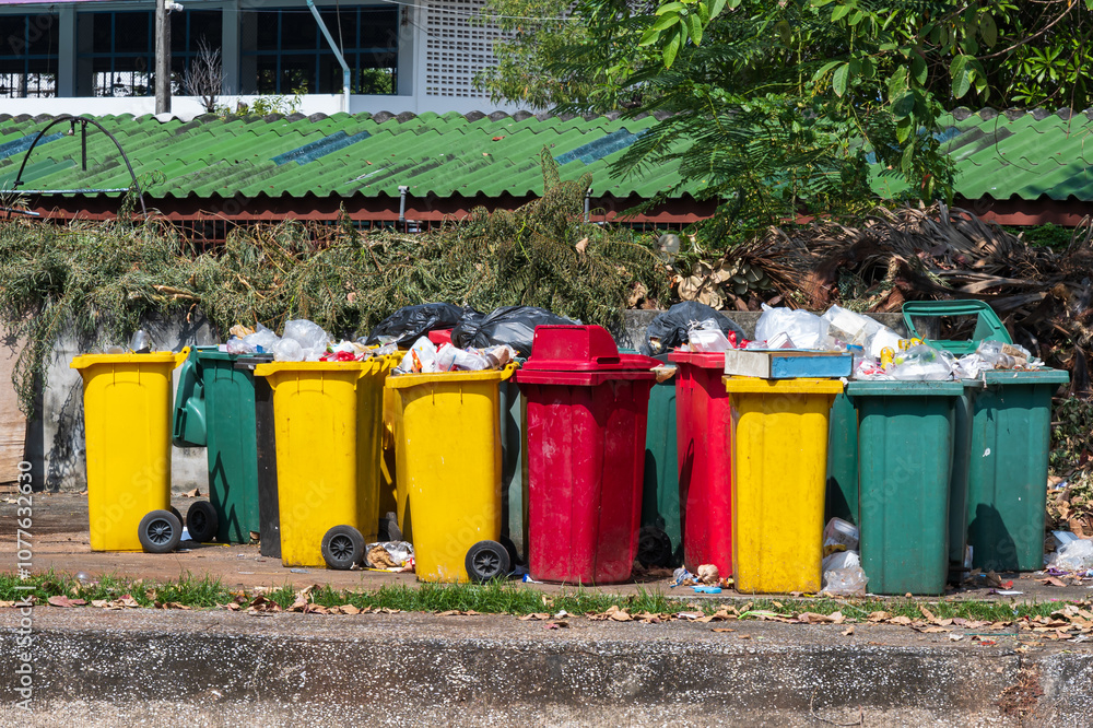 Collection area for public trash cans in the city.Row of different waste bin at the public park.Environmental protection.Garbage separation.The concept of environmental friendliness.