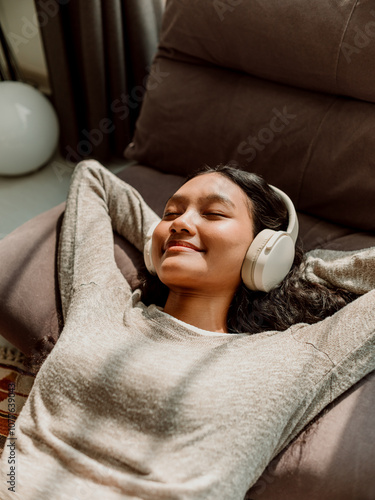 Relaxed Woman Enjoying Music With Headphones at Home