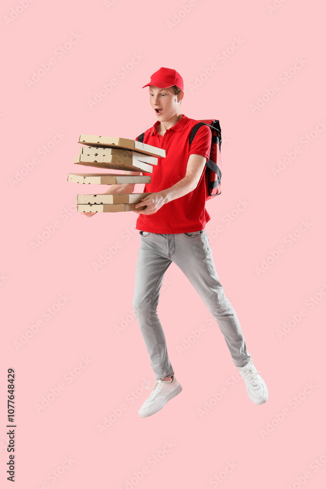 Jumping courier with pizza boxes on pink background Jumping courier with pizza boxes on pink background