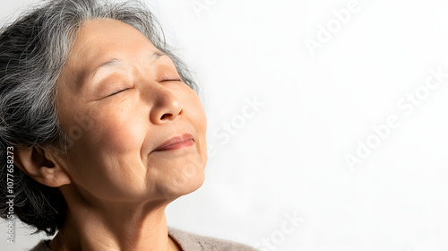 Elderly Woman Enjoying Deep Breaths with Eyes Closed