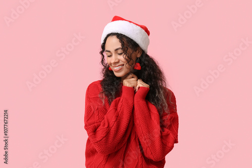 Joyful young woman in santa...