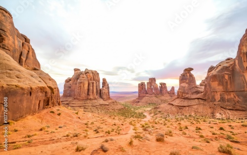 Canyonlands Majesty: A breathtaking panoramic view of towering sandstone formations under a soft, sunrise sky. The textures and colors evoke a sense of ancient wonder and timeless beauty. 