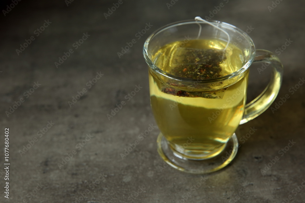 A Cozy and Warm Cup of Herbal Tea Sitting on a Rustic Surface for Full Enjoyment