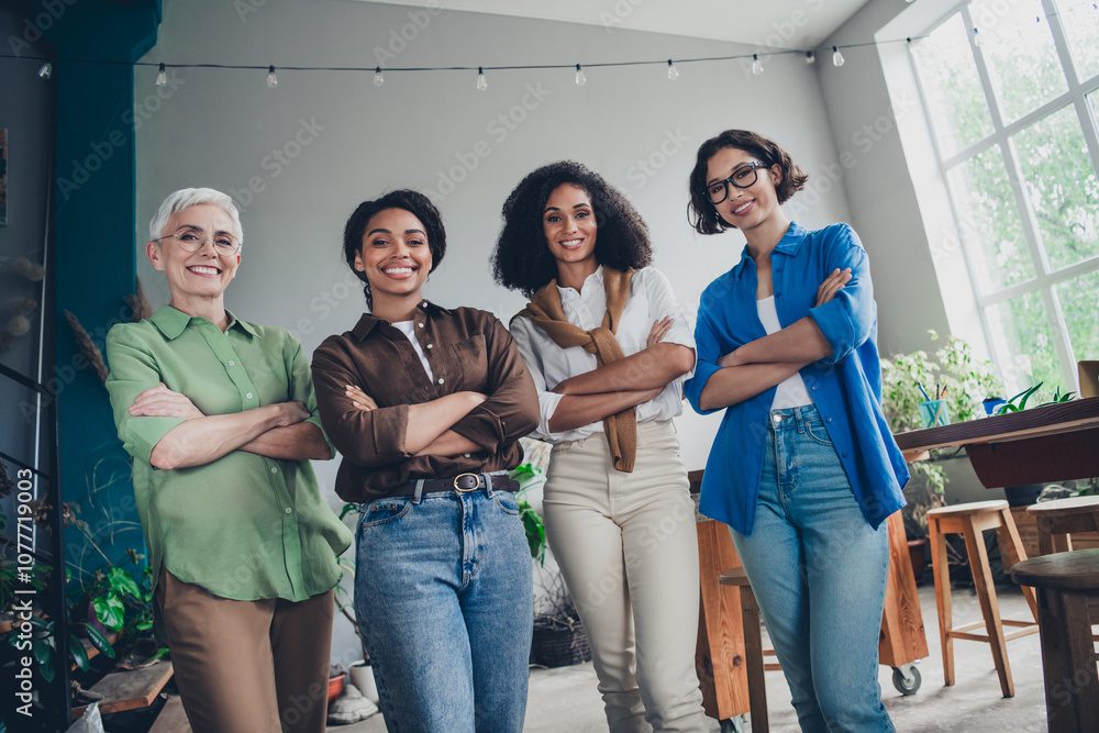 Obraz premium Portrait of team ambitious business women posing crossed arms modern interior office indoors