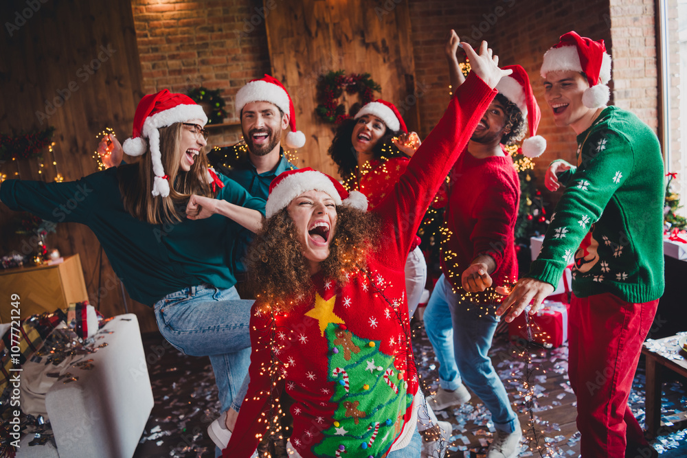 Naklejka premium Photo of cheerful young people friends group have fun excited cheerful dance cozy christmas party decor spacious apartment indoors