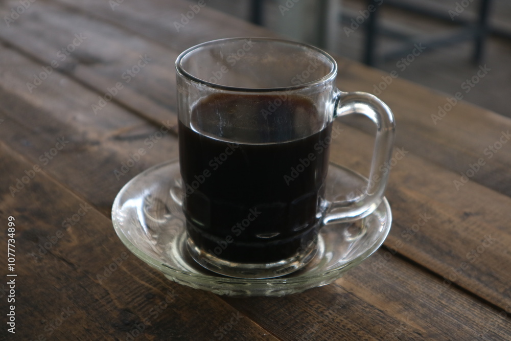 Brewed coffee on a rustic wooden table in a coffee shop (warkop) Brewed coffee on a rustic wooden table in a coffee shop (warkop)