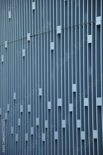 geometric facade with vertical lines and rectangular cutouts