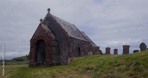 Wide shot of Kirkmadrine Chapel west door and graveyard photo