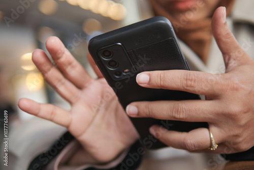  women hand holding smart phone sitting on cafe 