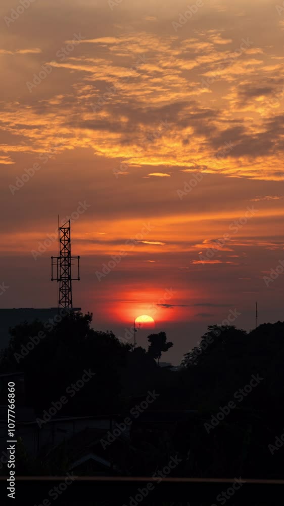 Vertical video - Timelapse of golden round sun rising slowly on a calm cloudy day Vertical video - Timelapse of golden round sun rising slowly on a calm cloudy day