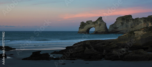 Sunset at Wharariki Beach, New Zealand. photo