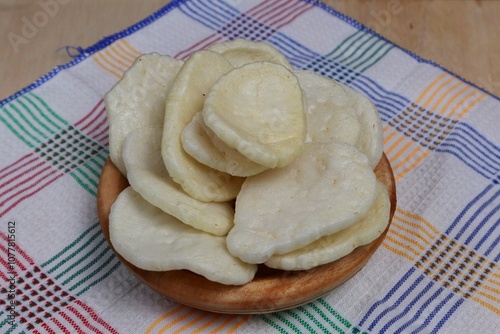 Fish crackers, Palembang crackers are a type of traditional Indonesian cracker originating from Palembang, Indonesia. Served on a wooden plate photo