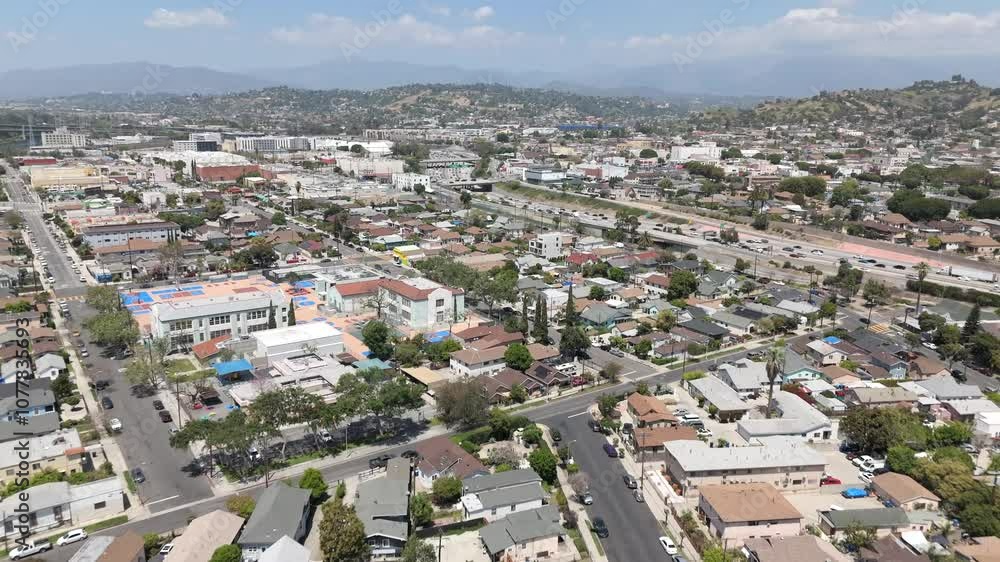 Aerial Flyover Of Suburban Streets In East Los Angeles neighborhood with Busy Hollywood Freeway. Aerial Flyover Of Suburban Streets In East Los Angeles neighborhood with Busy Hollywood Freeway.