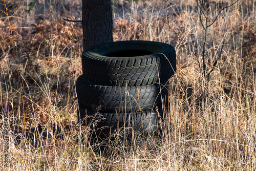 stack of tires in the woods 