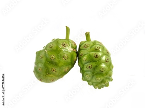 A fruit of noni, Morinda citrifolia, Cheese fruit with a flower and a leaf, used as ingredients, vegetable, beverage and traditional. photo