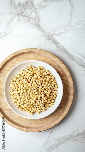 a close-up of a wooden tray filled with pumpkin seeds, nuts, walnuts, corn kernels, sunflower seeds, and cashews on a light-colored marble tabletop. This composition reflects themes of healthful livin photo