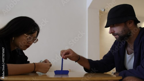 A Side View of a Couple Playing Connect Four - Close Up photo