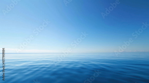 Deep blue sky stretching above a tranquil ocean, the water reflecting the clear sky like a mirror