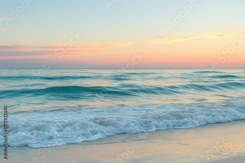 Soft morning light over the ocean, the sunrise casting a warm glow on the water and filling the sky with vibrant colors.