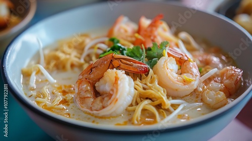 Closeup of Singaporean laksa with coconut milk shrimp and noodles served in a vibrant hawker center photo