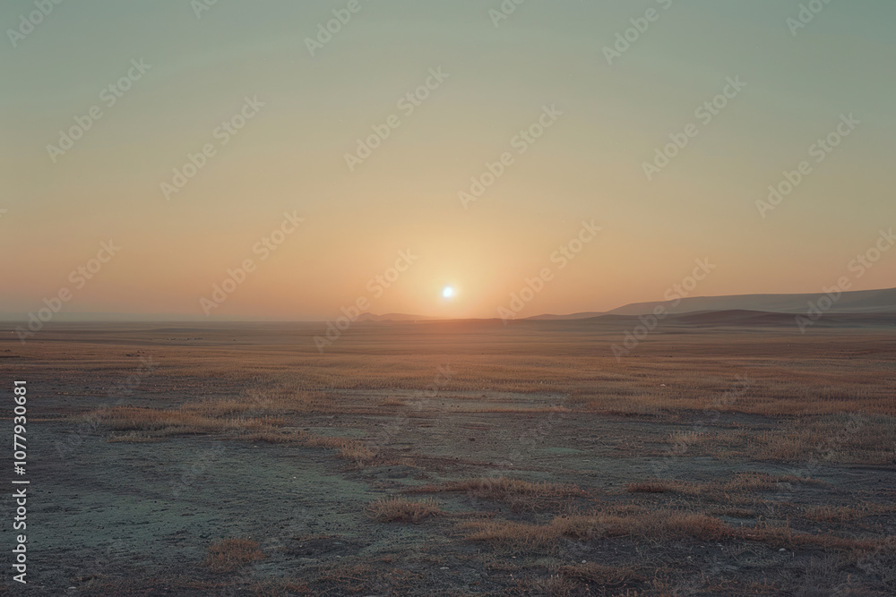 Obraz premium The morning sun peeking over the horizon in a remote area, filling the empty landscape with soft light.