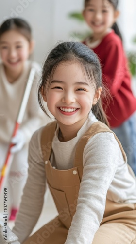 A joyful family cleans together, laughing as they celebrate the New Year