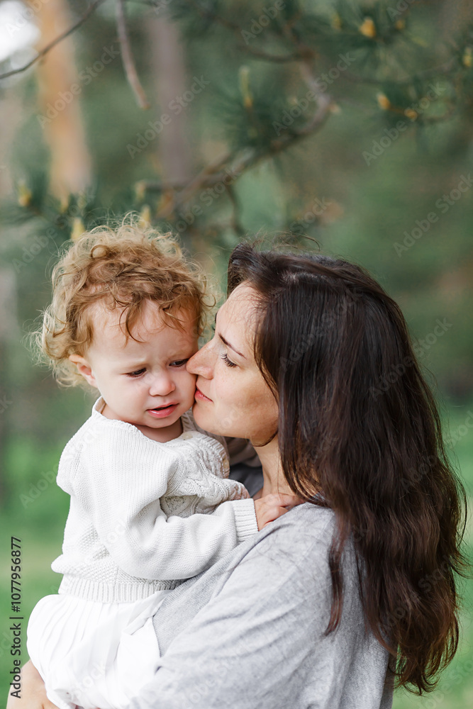 young mother holding her daughter and walking in green forest on a summer sunny day. Family having fun together. Childhood, parenting, happiness concept. mother's day. young mother holding her daughter and walking in green forest on a summer sunny day. Family having fun together. Childhood, parenting, happiness concept. mother's day.