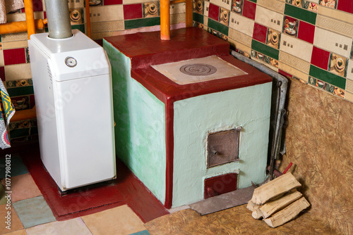 Stove and gas boiler for heating a rural house. Different types of fuel for heating in winter. photo