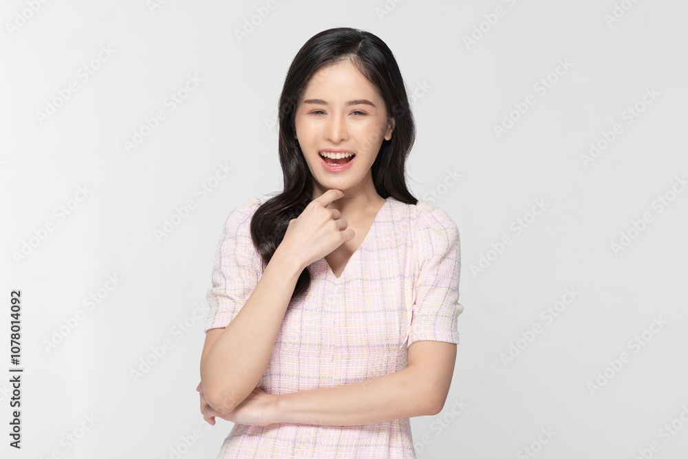 Cheerful Asian young woman with long, dark hair laughs warmly, exuding confidence and joy. She wears light textured blouse and has one hand under her chin in playful pose isolated on white background Cheerful Asian young woman with long, dark hair laughs warmly, exuding confidence and joy. She wears light textured blouse and has one hand under her chin in playful pose isolated on white background
