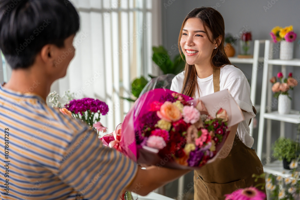 Asian young florist girl selling beautiful bouquet to customer in shop. Asian young florist girl selling beautiful bouquet to customer in shop.