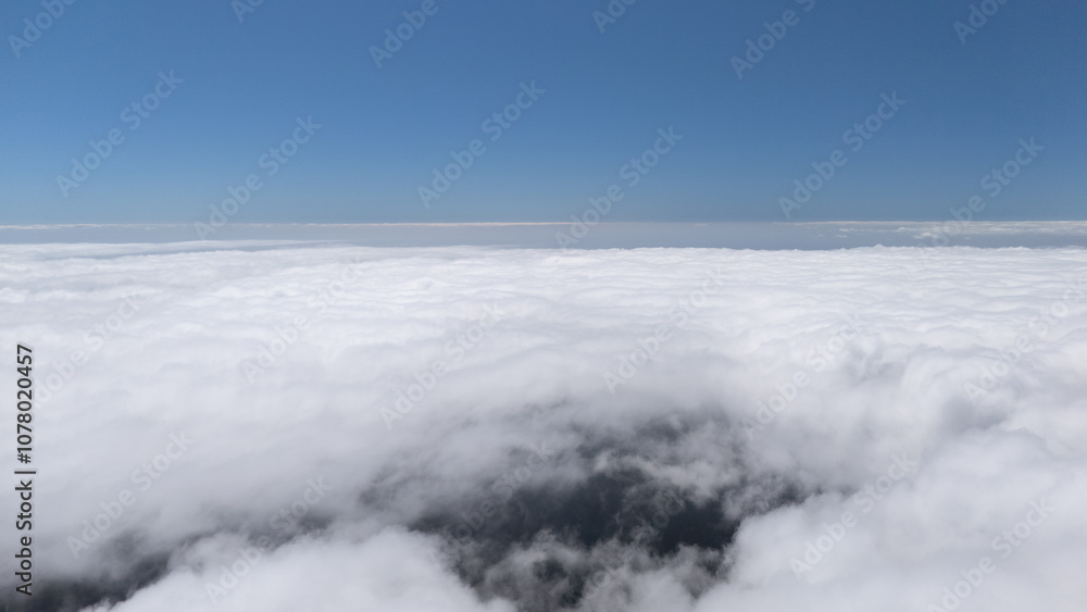 Aerial View of Expansive Cloudscape Under Clear Blue Sky Aerial View of Expansive Cloudscape Under Clear Blue Sky