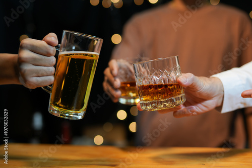 food and drink male friends are happy drinking beer and clinking glasses at a bar or pub. photo