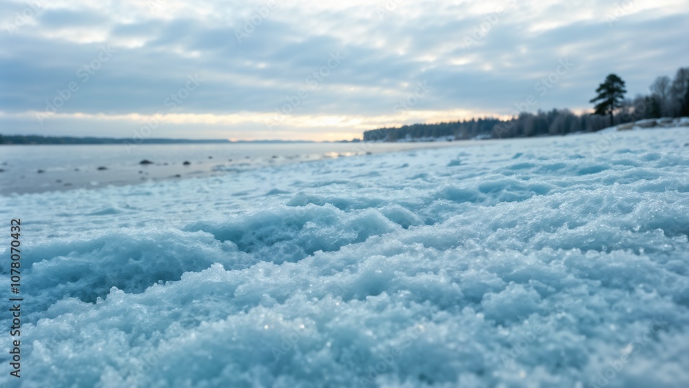 Fototapeta premium Frost-covered beach at dawn with a serene atmosphere