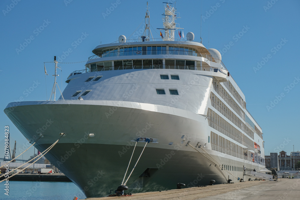 Ultra luxury cruiseship cruise ship liner yacht Whisper or Shadow in port docked at terminal with harbor infrastructure and marine traffic Ultra luxury cruiseship cruise ship liner yacht Whisper or Shadow in port docked at terminal with harbor infrastructure and marine traffic