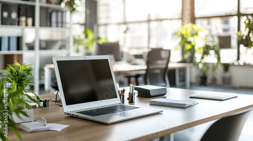 Laptop on office desk, sunny room, modern workplace