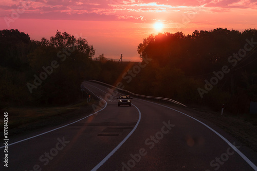 Empty long mountain road to the horizon on a sunny summer day at bright sunset - speed motion blur effect