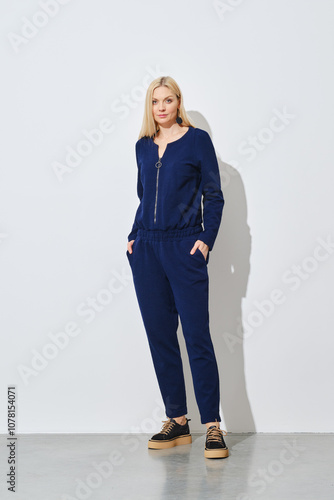 Blonde woman posing in knitted pantsuit