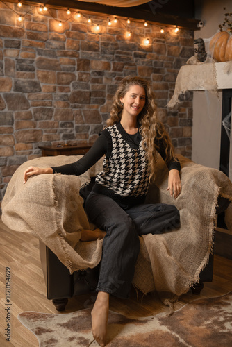 Cozy autumn evening featuring a woman in a houndstooth sweater relaxing at home near a fireplace