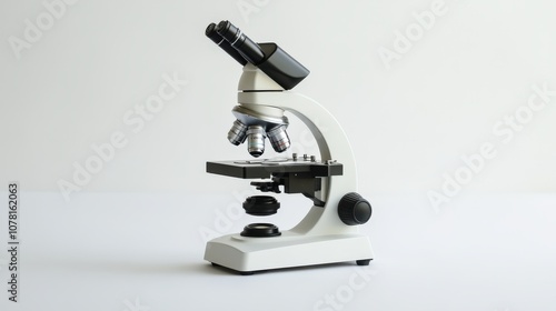 White and Black Compound Light Microscope on White Surface