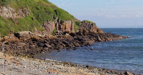 Looking north up the rocky Tarbet beach, photo