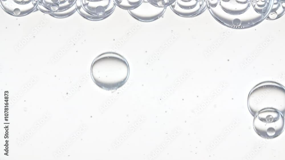 Macro Shot of Different Sized Clear Air Bubbles in Clear Water Rising up on White Background. Body Care Cosmetics Concept. Essence, Liquid Bubble, Molecule. Slow Motion . High quality FullHD footage Macro Shot of Different Sized Clear Air Bubbles in Clear Water Rising up on White Background. Body Care Cosmetics Concept. Essence, Liquid Bubble, Molecule. Slow Motion . High quality FullHD footage
