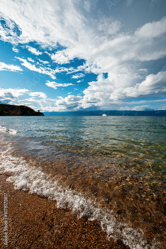 the sandy shore of Lake Baikal at sunset photo