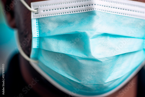 Nurse in mask and gown, essential protection during hospital procedures photo