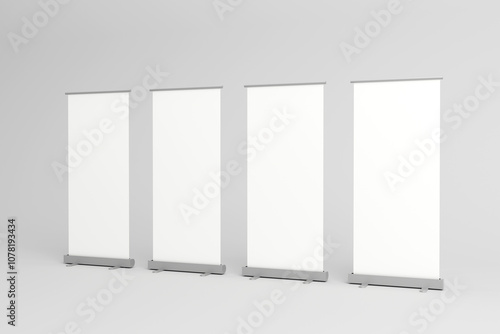Obraz na płótnie Four blank roll-up banners lined up for promotional displays.