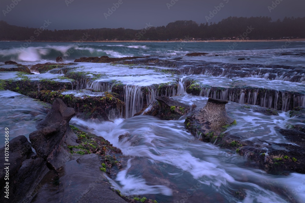 Coastal landscape with cascading waves at dusk. Coastal landscape with cascading waves at dusk.